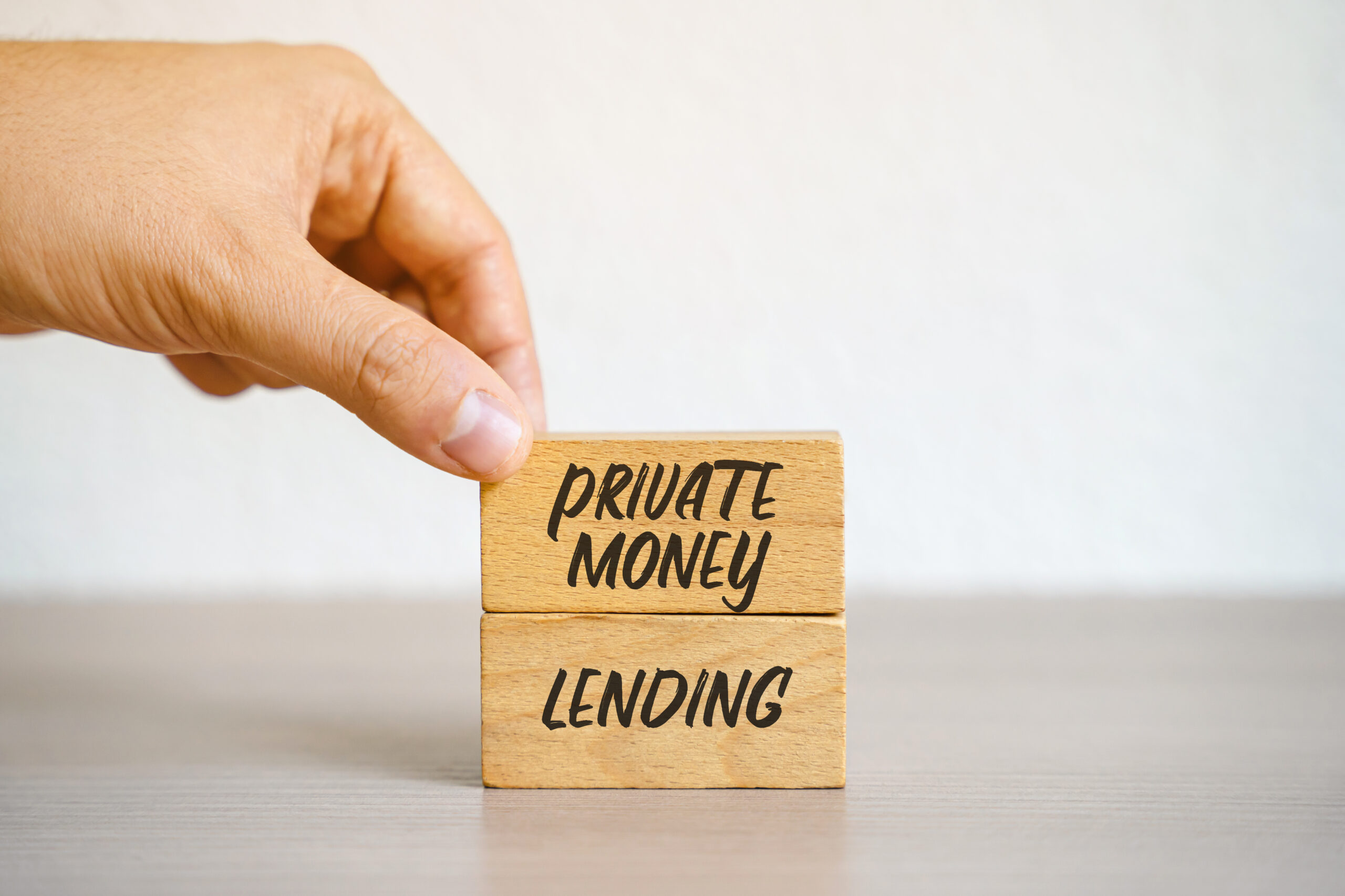 Private money lending. Providing loans to individuals or businesses by private entities or individuals rather than traditional financial institutions. Business and finance concept. Wood blocks and man